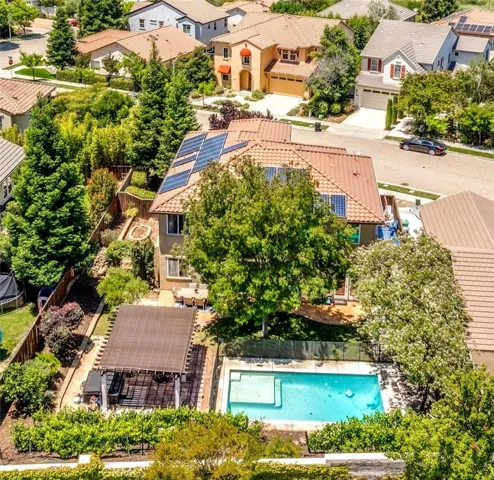 This property has the perfect backyard for summer: A refreshing pool, grassy area, multiple seating areas and a garden area on the side of the home.