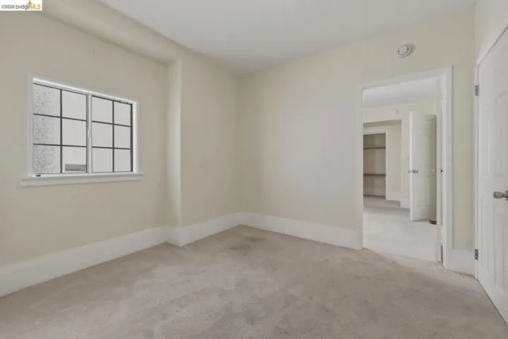 Neutral-toned carpet flooring and light wall finishes define this room