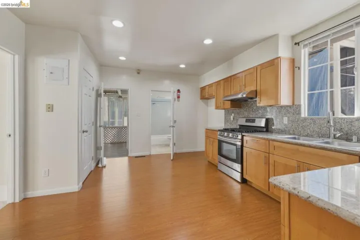 Kitchen area featuring wood-finish flooring, recessed lighting, and light wood cabinetry