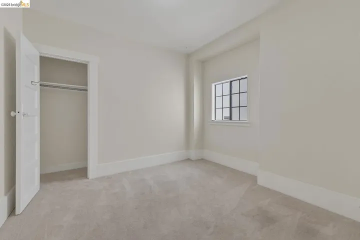 Room featuring light-colored carpeting, neutral wall paint, and white baseboards