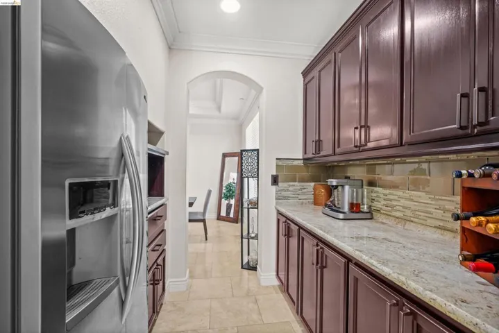 Stainless steel refrigerator and dark wood-finish cabinetry