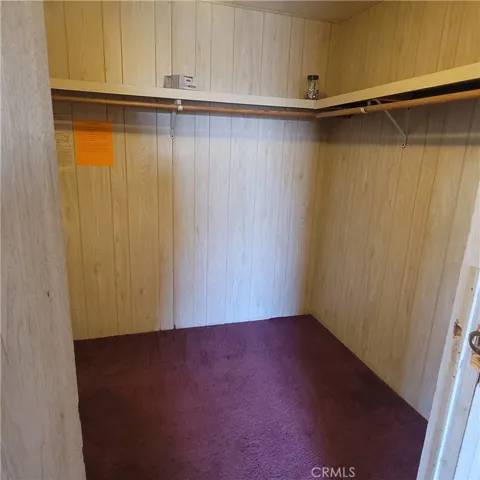 Primary bedroom walk in closet