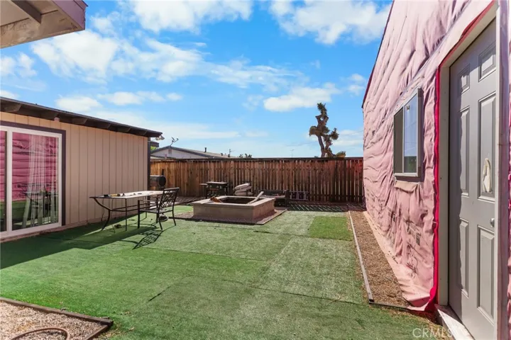 Back Yard, built-in fire pit, entry into 3 car garage