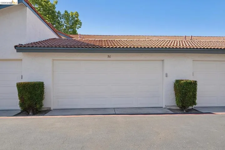 White stucco exterior with a terra cotta tile roof