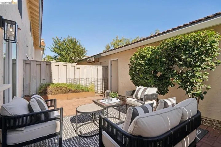 Outdoor patio with brick pavers and a built-in planter box