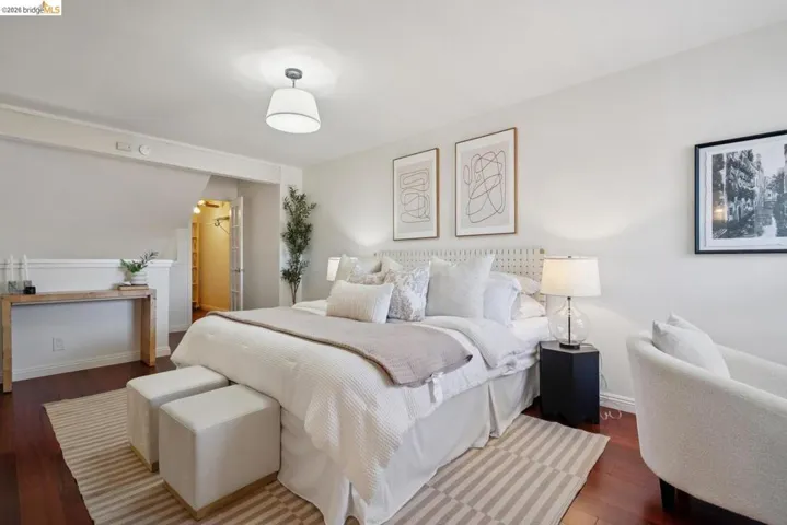 Bedroom featuring dark wood-finish flooring and a neutral color palette