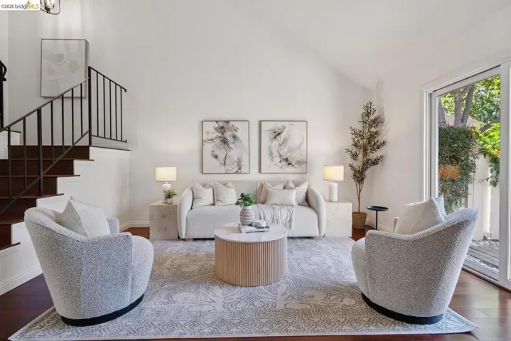 Living area featuring high vaulted ceilings and dark wood-finish flooring
