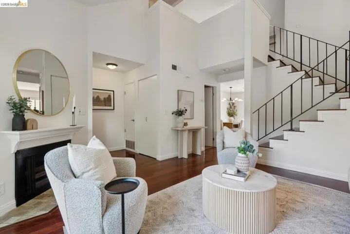 Living area featuring soaring ceilings and dark wood-finish flooring