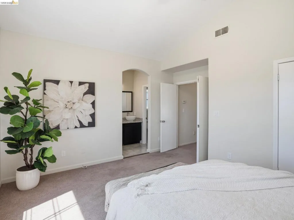 Spacious room with vaulted ceilings and neutral wall tones