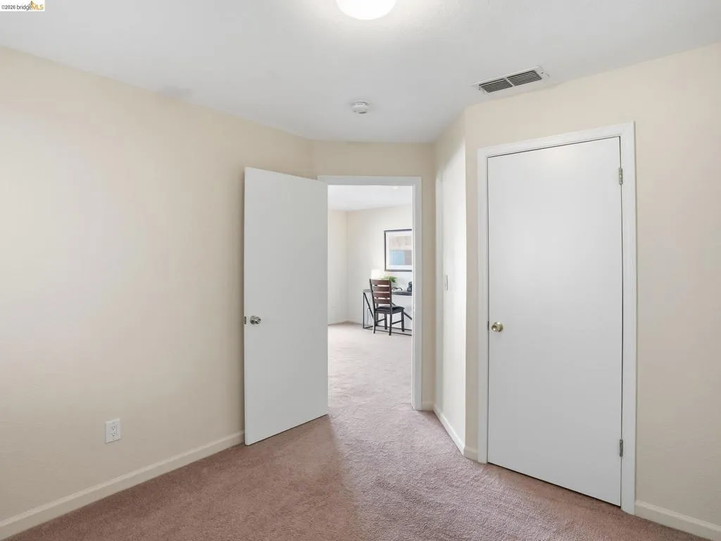 Neutral-toned walls paired with brown carpeting