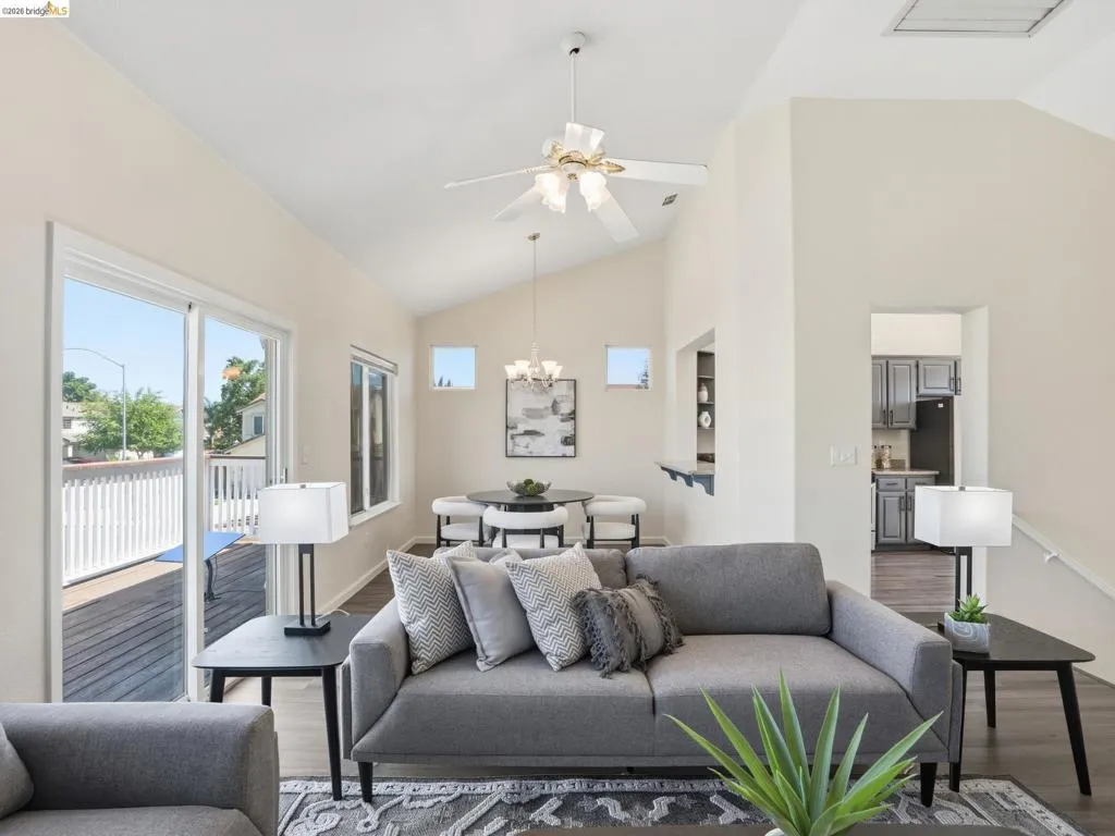 Vaulted ceilings in this living area with wood-finish flooring