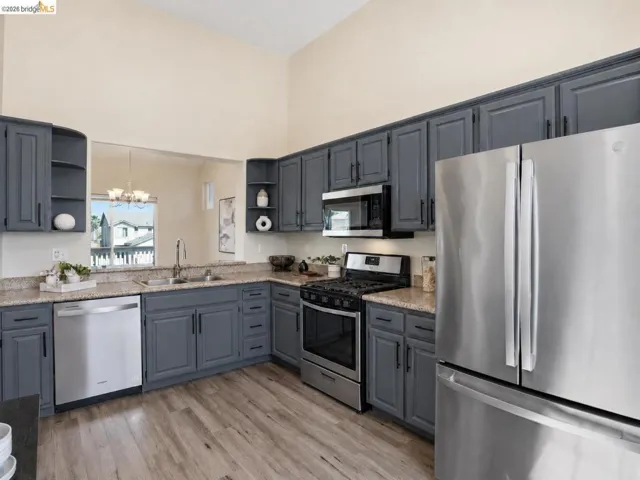 Kitchen featuring shaker-style cabinetry, light-toned countertops, and wood-finish flooring