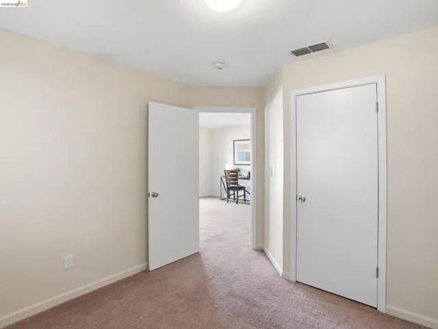 Neutral-toned walls paired with brown carpeting