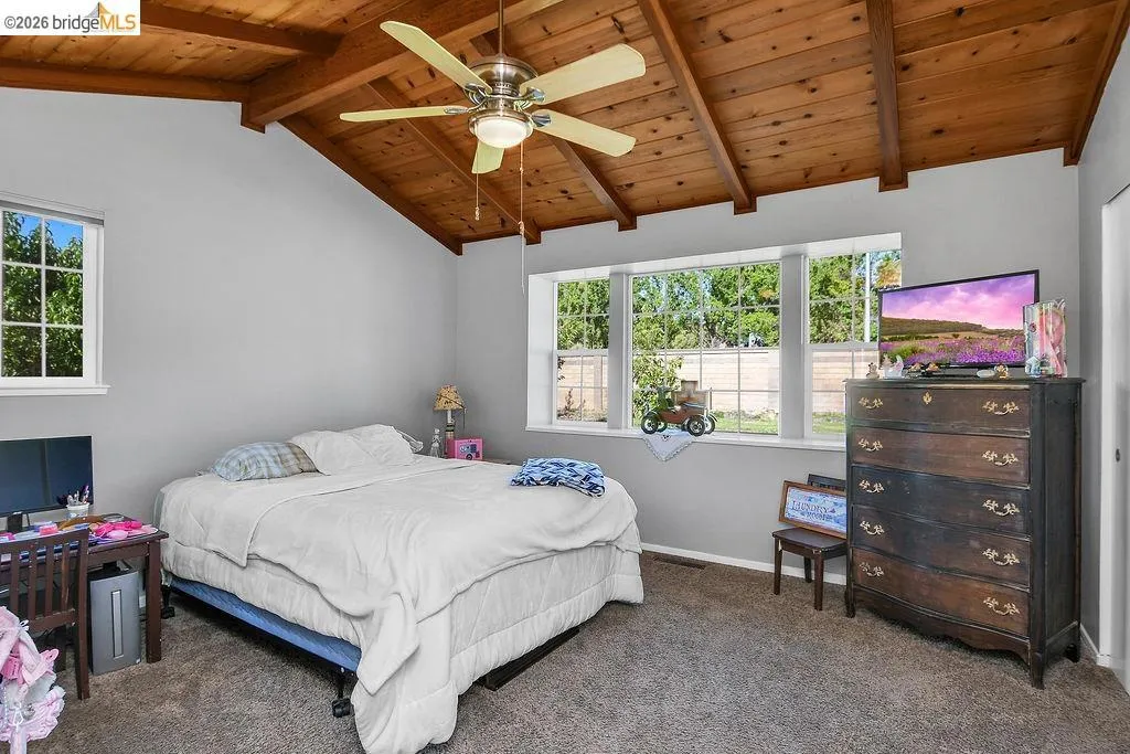 Vaulted wood-paneled ceiling with exposed beams