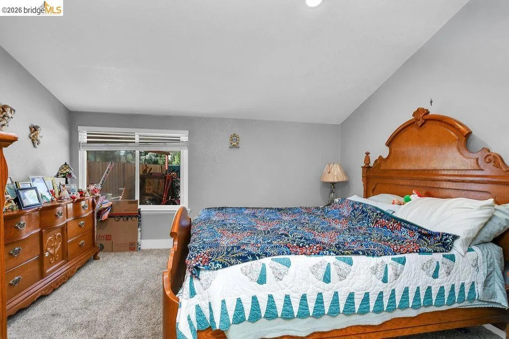 Bedroom featuring neutral gray walls and plush carpeting