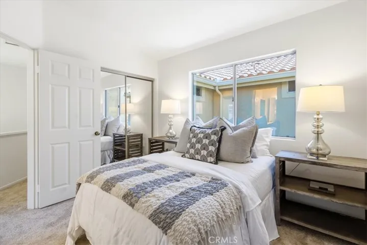 Primary bedroom with natural light and neutral tones.