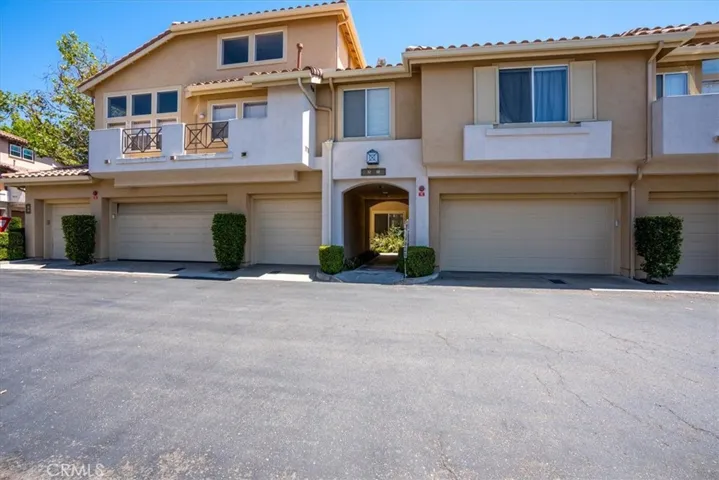 Exterior building view highlighting architecture and open driveway area.