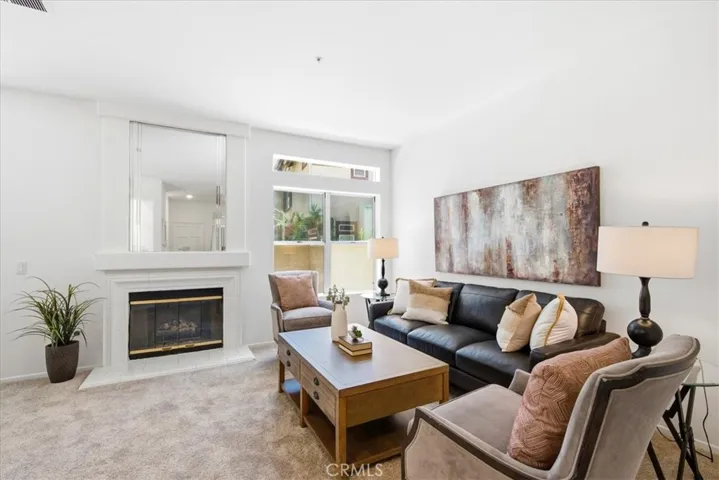 Bright living room with fireplace and comfortable seating area.