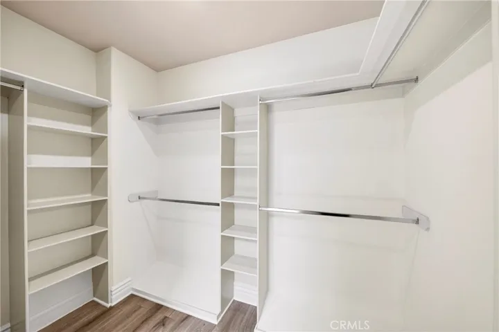 Master walk in closet connected to bathroom.