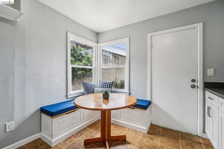 Corner window seat with built-in storage and white paneling