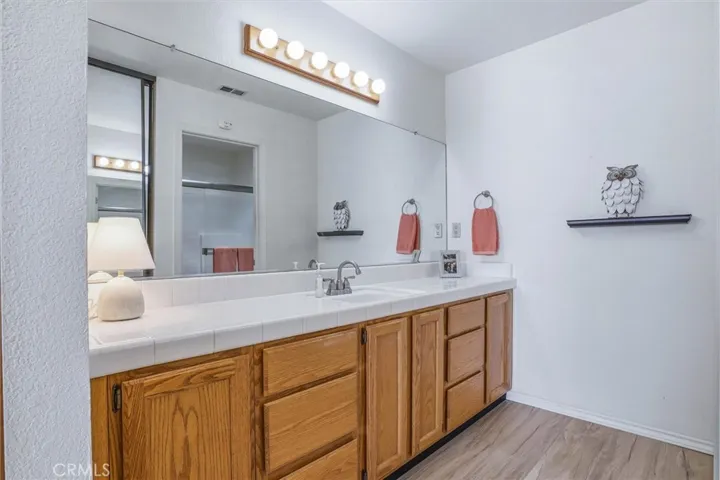 Primary bathroom with large vanity providing tons of storage