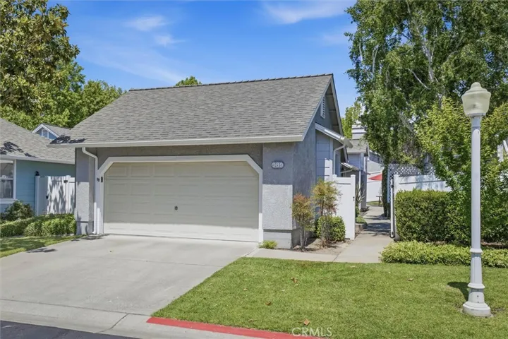 Expansive front yard with mature landscaping and 2-car garage