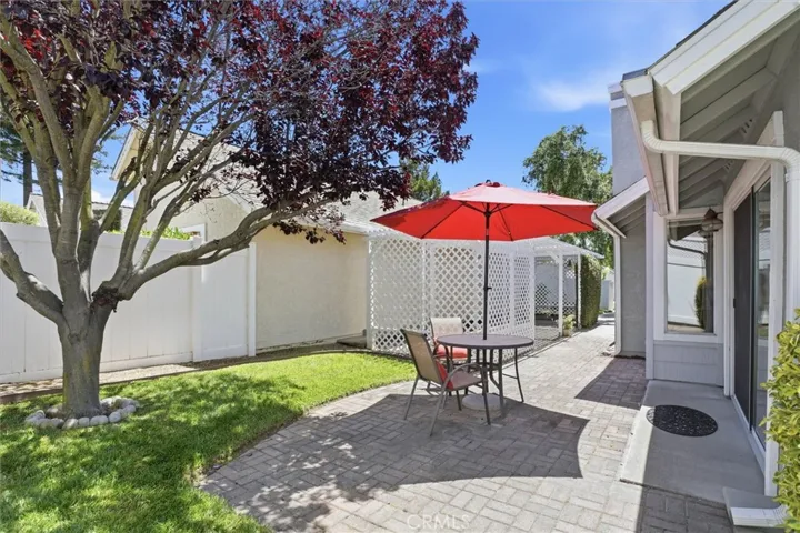 Exterior yard with nice stone patio, mature landscaping and ample privacy