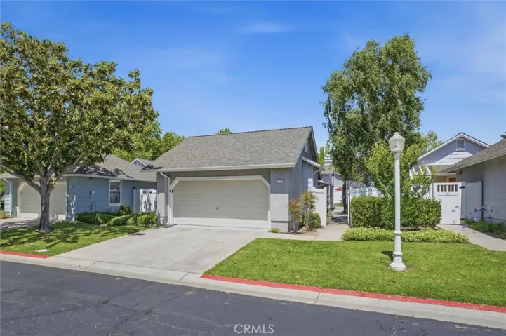 Expansive front yard with mature landscaping and 2-car garage