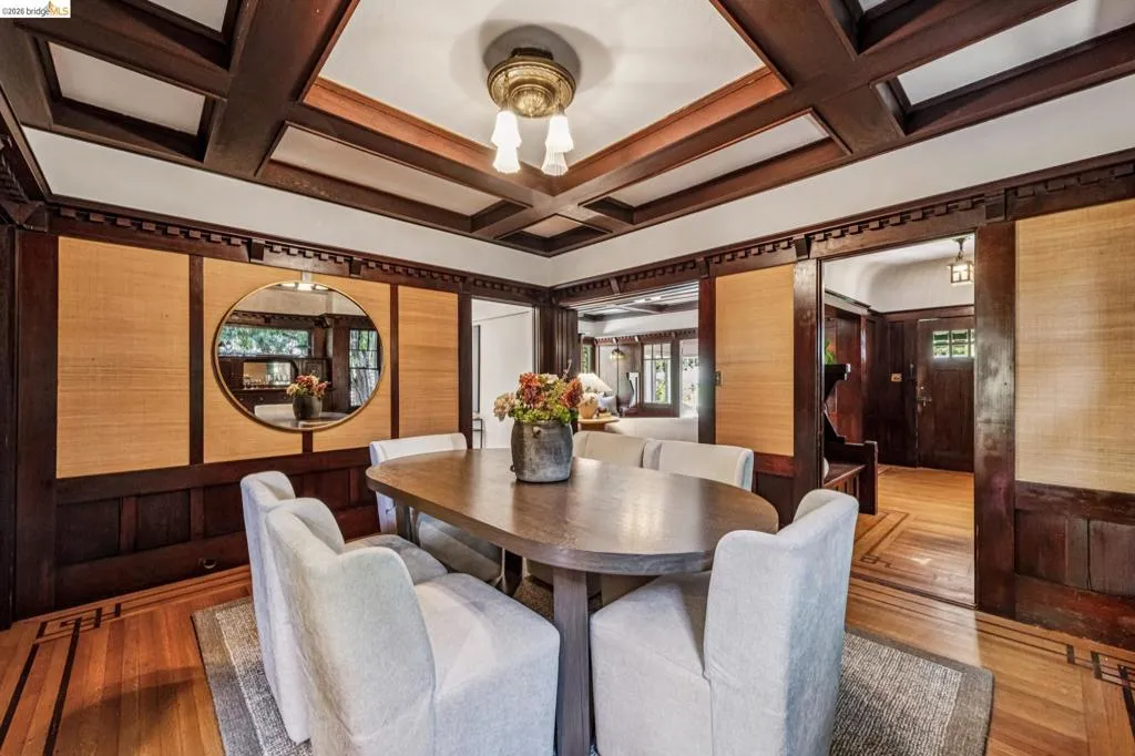 The dining room will make you want to make history of your own with it's coffered wood ceiling, and amazing built-in hutch and wood paneling with woven inserts