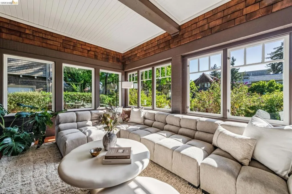 Sunroom featuring a white beadboard ceiling, wood-shingle wall accents, and multiple windows