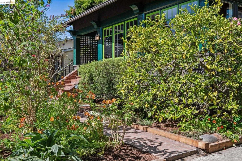 Lush landscaping with mature trees and vibrant flowering plants