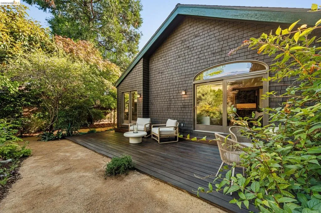 Exterior featuring dark shingle siding and a gabled roofline