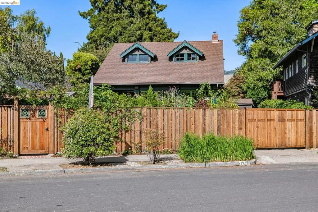 This handsome style craftsman-style brown shingled bungalow home is fully fenced for privacy!