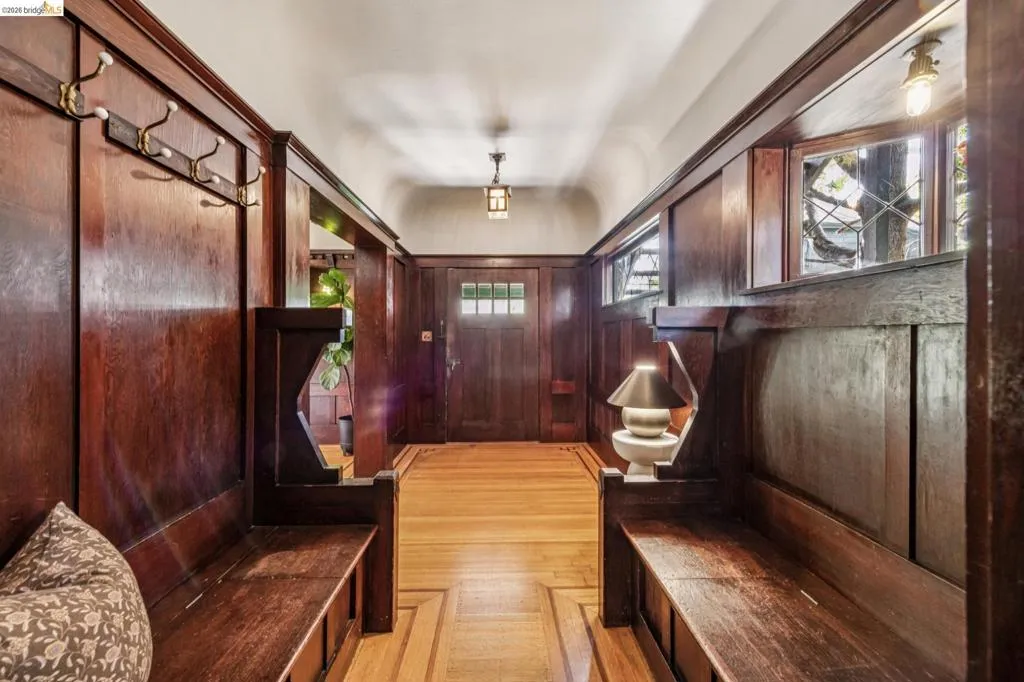 This is an entryway for the ages featuring extensive wood paneling and built-in benches.