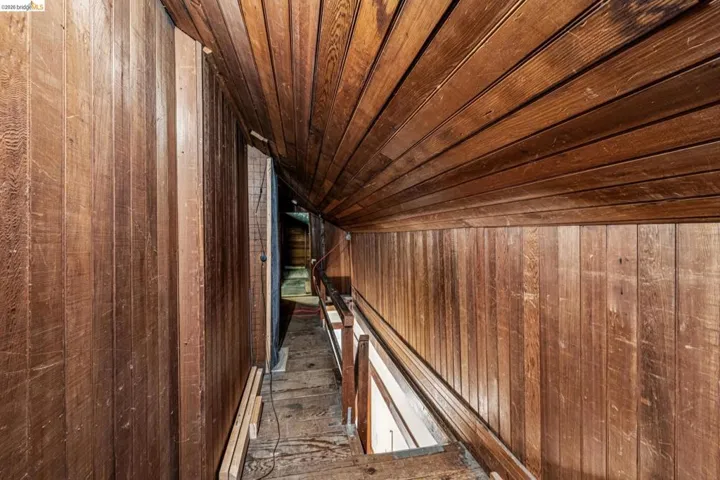 Natural wood paneling throughout, extending to the sloped ceiling