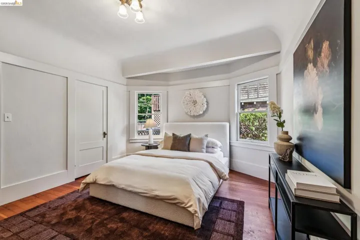 Bedroom featuring bay window and a period ceiling light fixture.