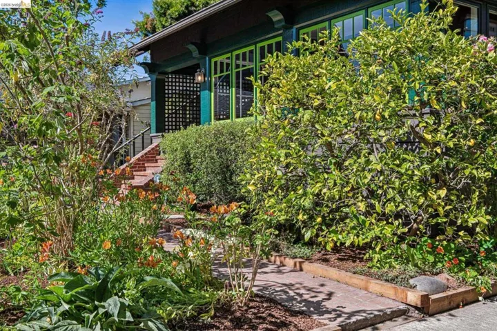 Lush landscaping with mature trees and vibrant flowering plants