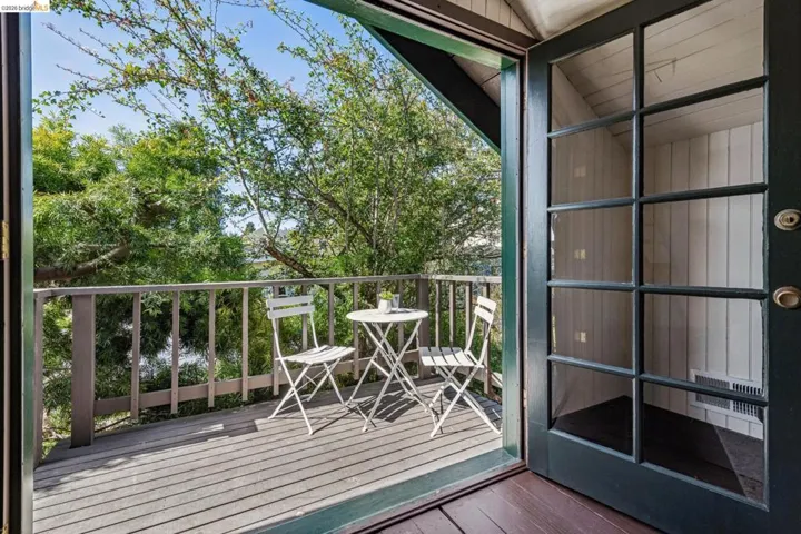 Exterior deck featuring a wood-plank surface and painted railing