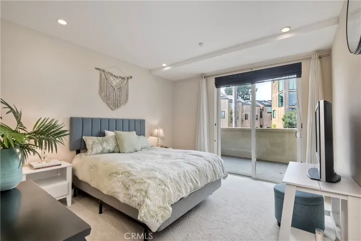 Bedroom with adjacent balcony.