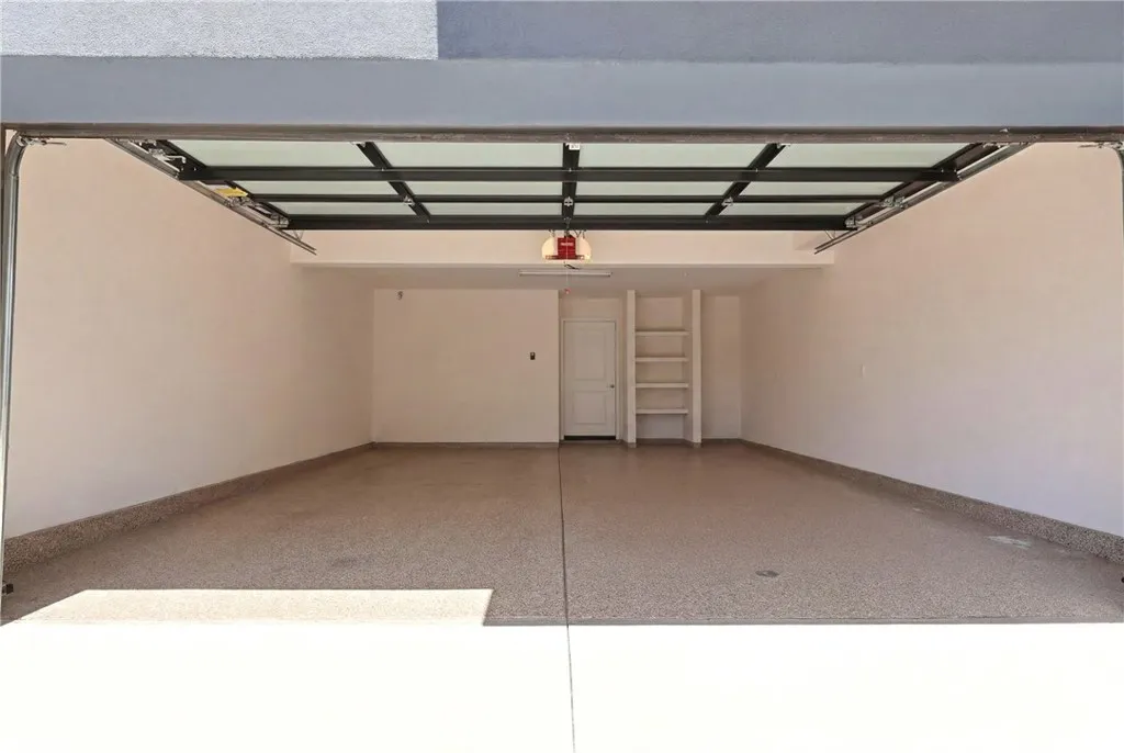 Garage had items digitally removed. Has a Tesla charger, whole house water filter and Rinnai tankless water heater system