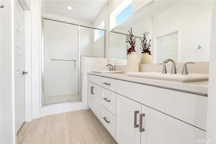 dual sink vanity and large walk in shower