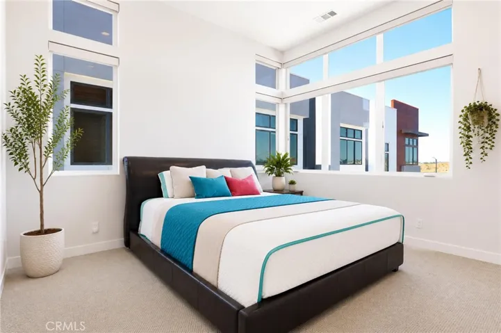master bedroom with tall ceilings and windows to take in breathtaking sunsets or close the Hunter Douglas automatic blinds for privacy
