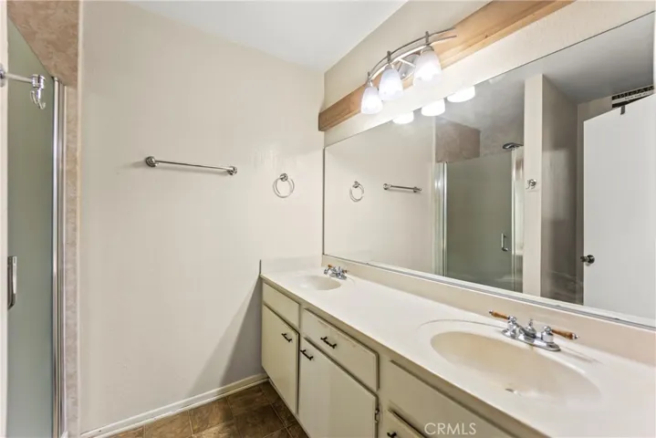 Dual sinks, updated light fixture, and lots of storage space in primary bath #1