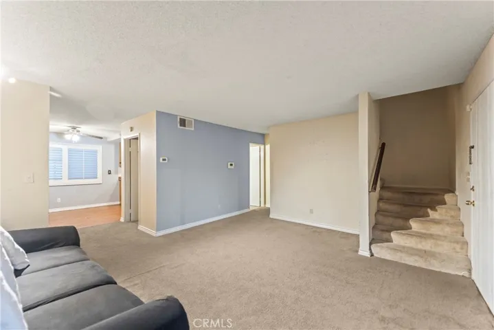 Living room opens to dining / kitchen.