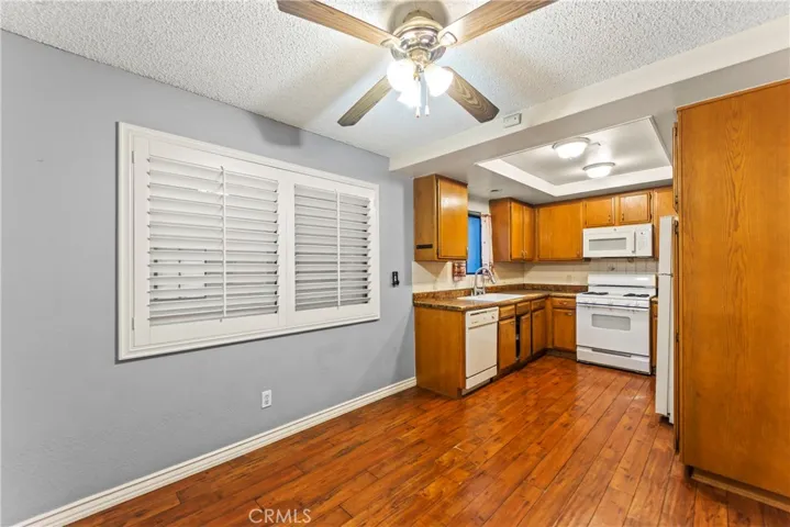 Dining area has plantation shutters & ceiling fan