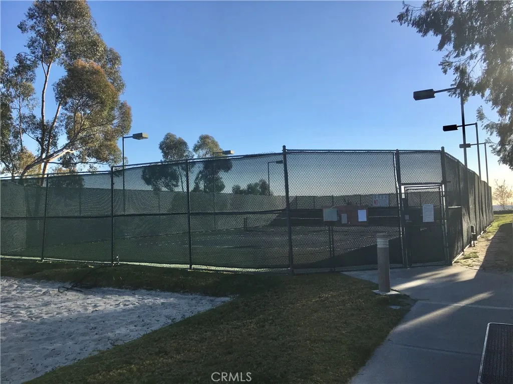 Tennis court next to community pool