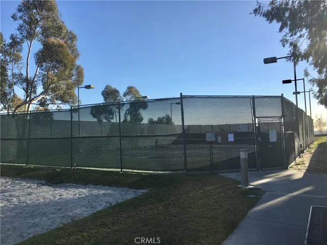 Tennis court next to community pool