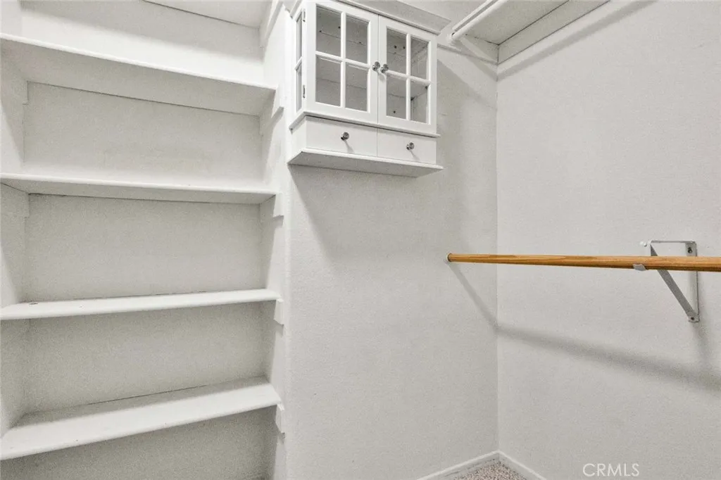 Primary bedroom walk-in closet