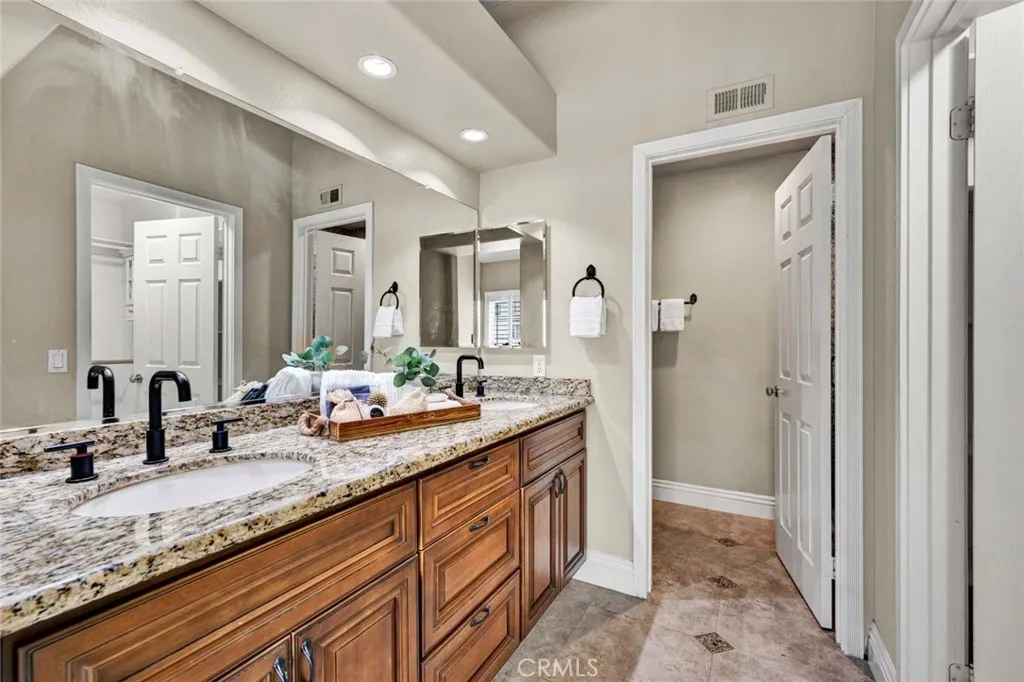 Remodeled primary bathroom featuring a spacious dual-sink vanity and modern finishes.