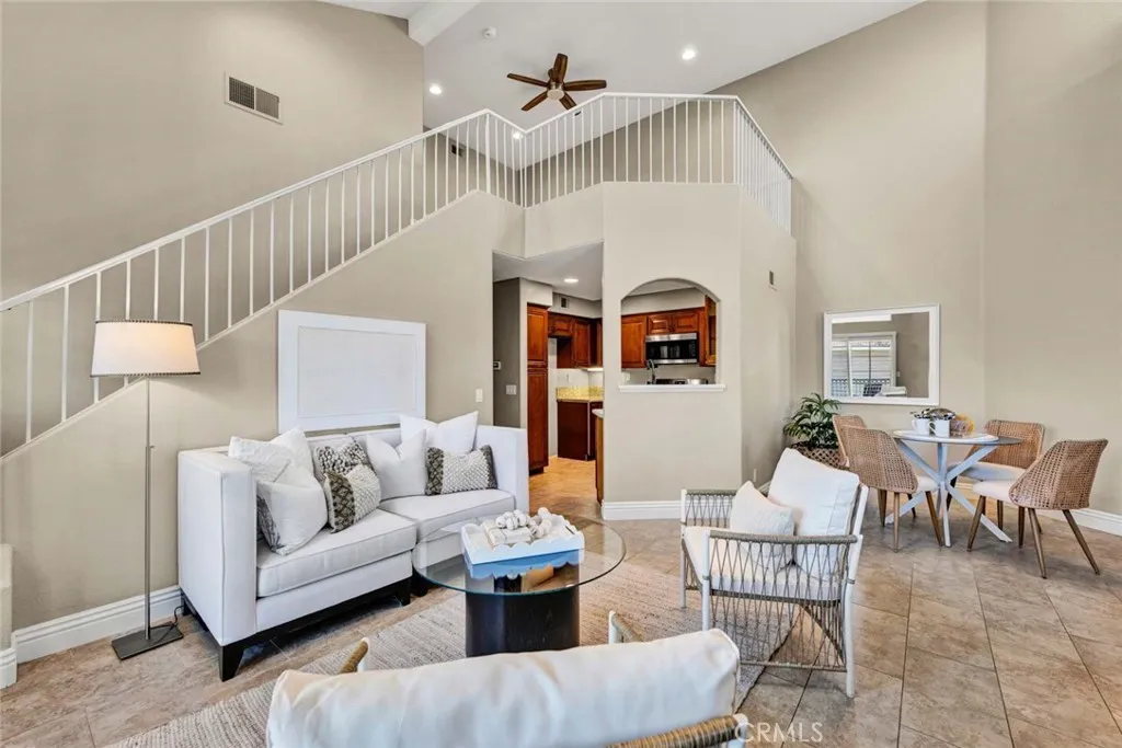 Open stairwell leads to a spacious, light-filled loft area that is perfectly suited for a home office, gym, or entertainment space.